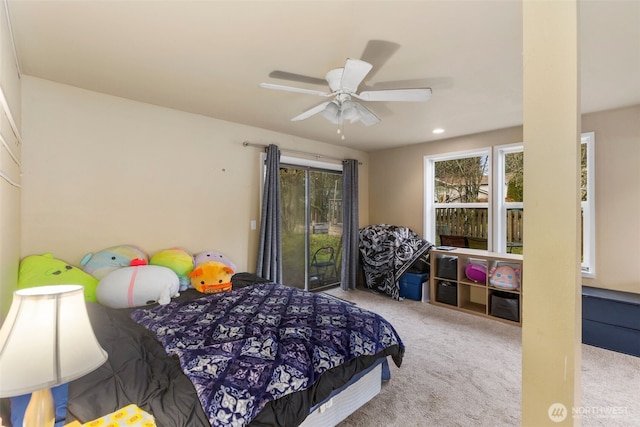 bedroom featuring a ceiling fan and light colored carpet