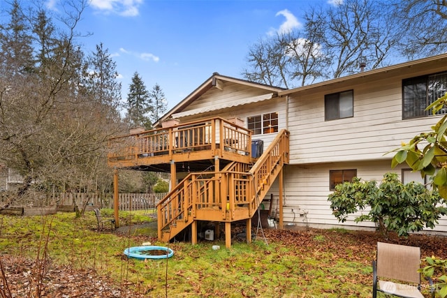 exterior space featuring stairs, fence, and a wooden deck