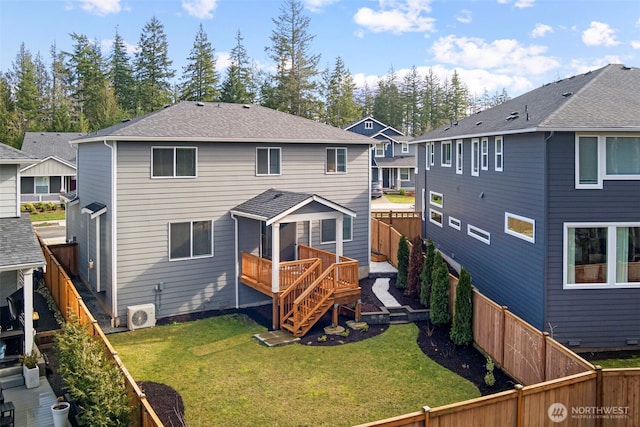 rear view of property with a fenced backyard, a residential view, stairs, a yard, and ac unit