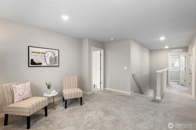 living area featuring recessed lighting, visible vents, light carpet, an upstairs landing, and baseboards