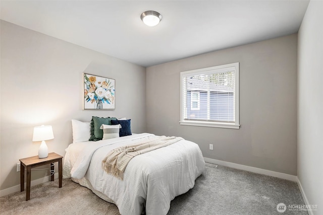 bedroom featuring light carpet and baseboards