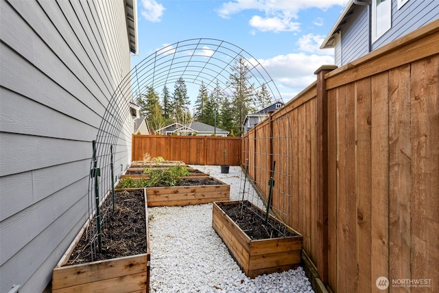 view of yard featuring a fenced backyard and a vegetable garden