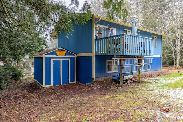 back of property with a shed and an outdoor structure