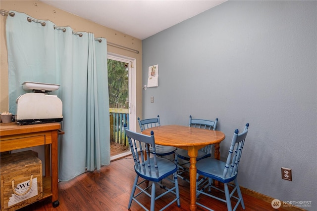 dining area featuring dark wood finished floors