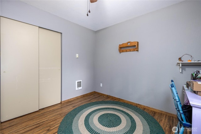 office space with ceiling fan, wood finished floors, visible vents, and baseboards