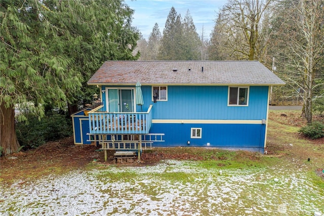 back of property featuring a wooden deck