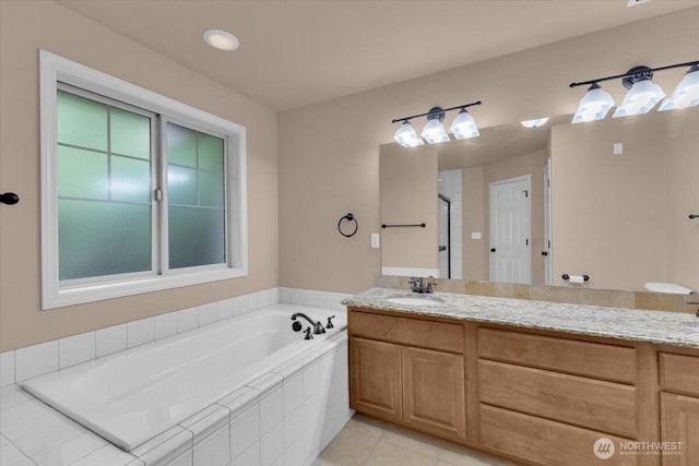 bathroom with a shower, a garden tub, vanity, and tile patterned floors