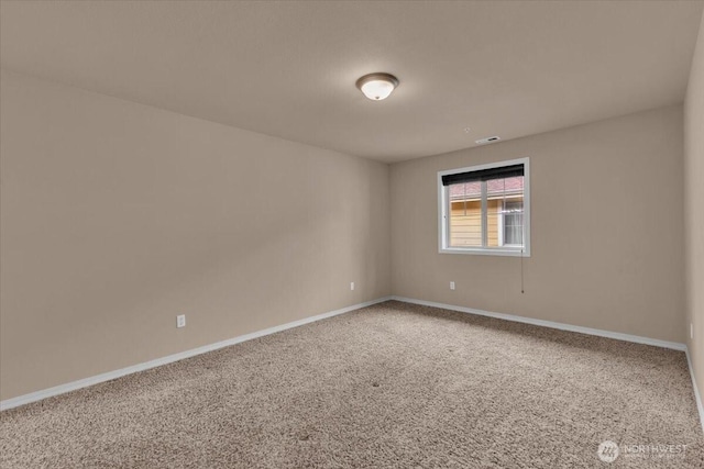 carpeted empty room featuring visible vents and baseboards