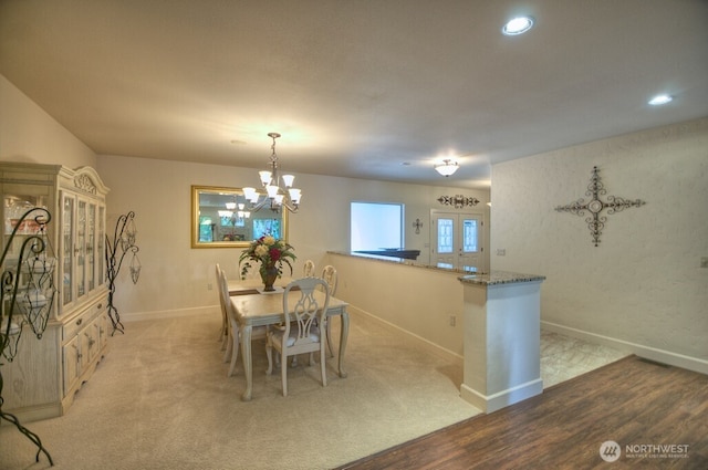 dining space with an inviting chandelier, baseboards, and recessed lighting