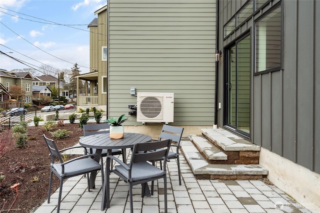 view of patio / terrace featuring entry steps, outdoor dining area, and ac unit