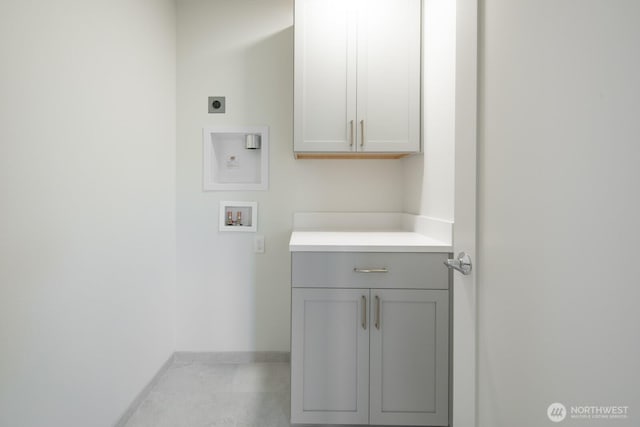 clothes washing area with hookup for a washing machine, cabinet space, baseboards, and hookup for an electric dryer