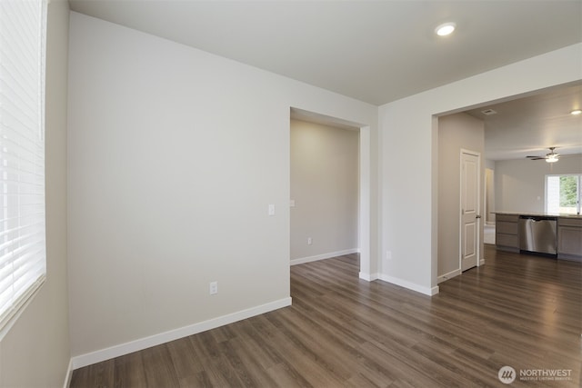 spare room featuring a ceiling fan, baseboards, dark wood-style flooring, and recessed lighting