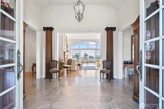 entryway featuring high vaulted ceiling and a notable chandelier