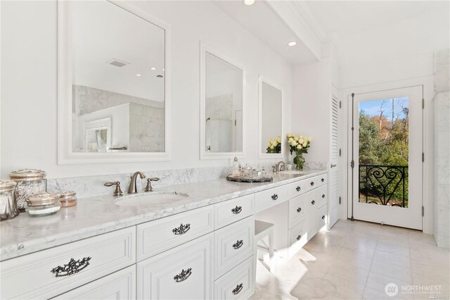 bathroom with double vanity, a sink, and recessed lighting