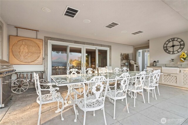 view of patio featuring visible vents and an outdoor kitchen