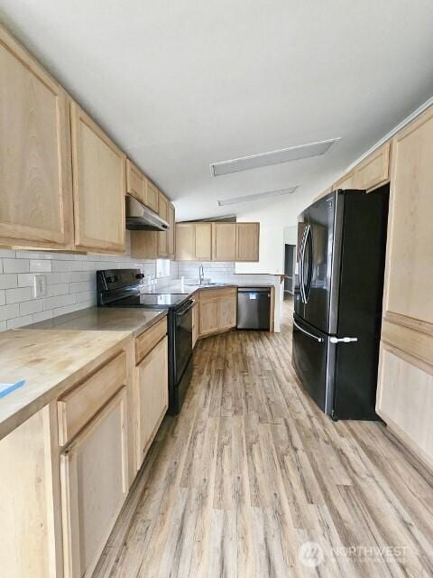 kitchen featuring light brown cabinets, wooden counters, backsplash, black appliances, and light wood finished floors