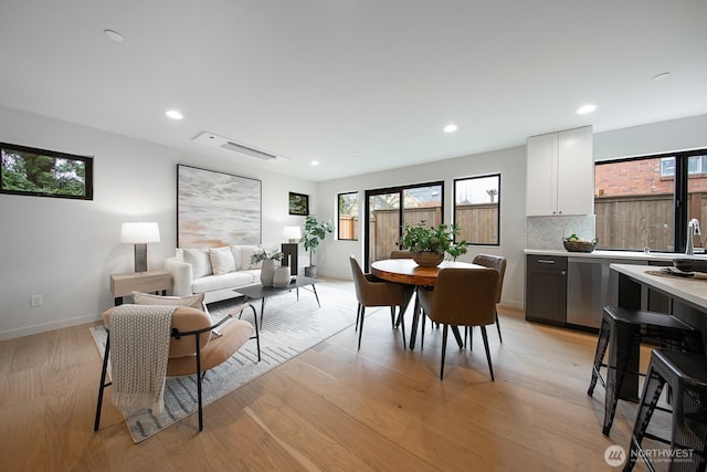 dining room featuring light wood-style floors, recessed lighting, and baseboards