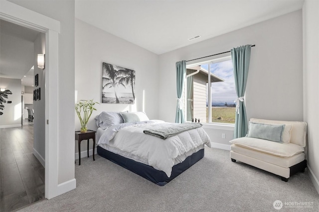 bedroom with baseboards and visible vents