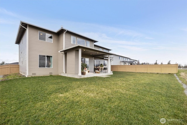 rear view of property featuring crawl space, a patio area, fence, and a lawn