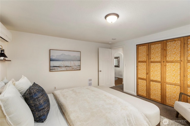 bedroom featuring carpet and a wall mounted AC