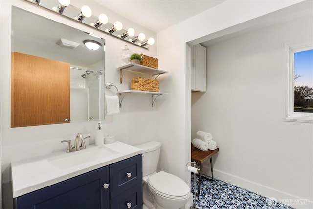 bathroom with toilet, baseboards, a shower, and vanity