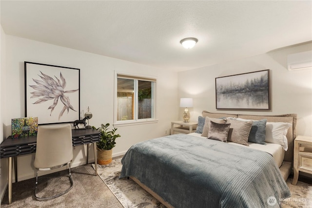 carpeted bedroom with a wall mounted air conditioner and baseboards