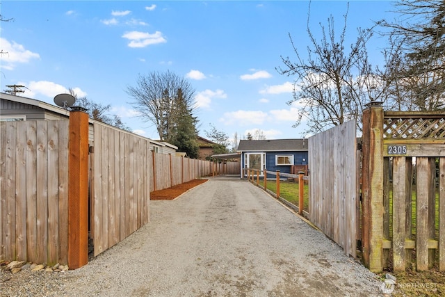 view of road with a gate, driveway, and a gated entry