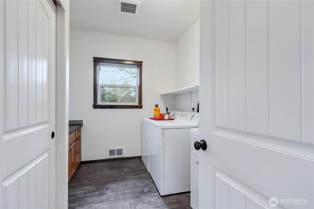 clothes washing area featuring laundry area, baseboards, visible vents, and washing machine and clothes dryer