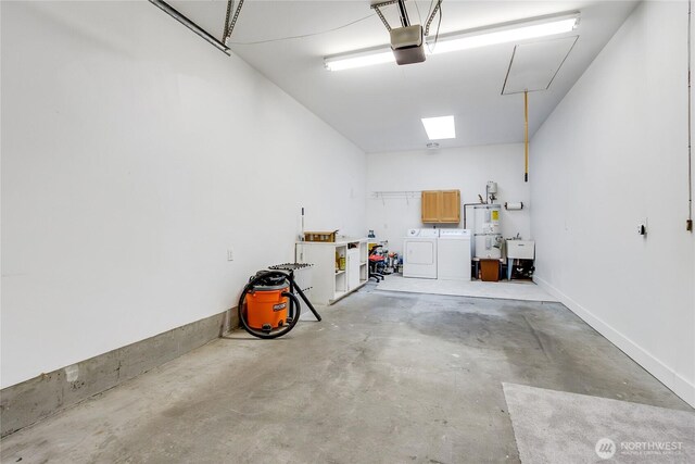 garage featuring water heater, washer and clothes dryer, a sink, and a garage door opener