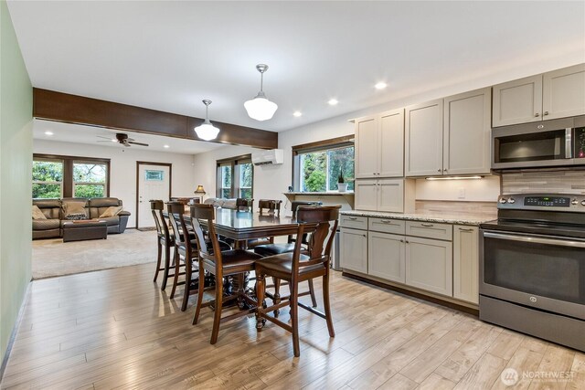 dining space featuring light wood finished floors, a wall mounted AC, and recessed lighting