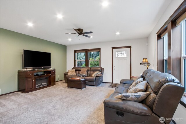 living room with recessed lighting, light colored carpet, and baseboards