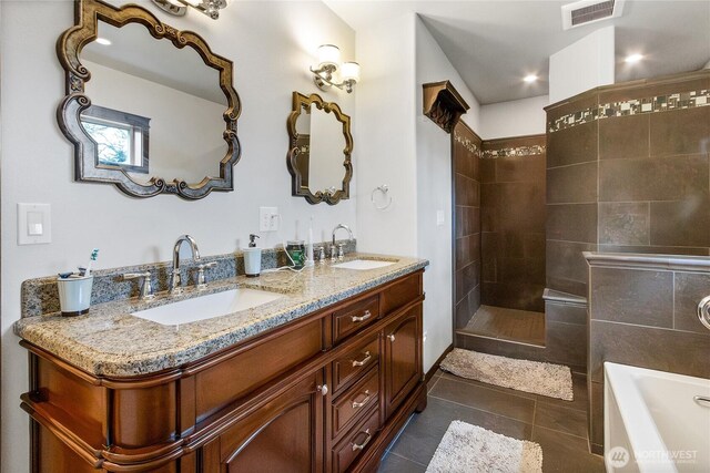 full bath with visible vents, a sink, a garden tub, and tile patterned floors