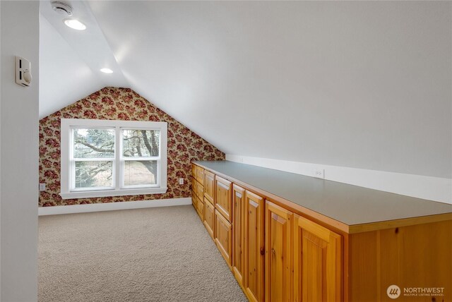 additional living space featuring recessed lighting, light carpet, vaulted ceiling, and wallpapered walls