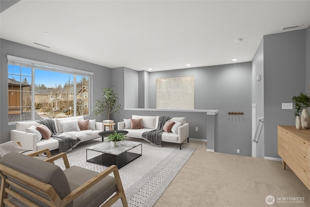 living room with carpet floors, recessed lighting, visible vents, and baseboards