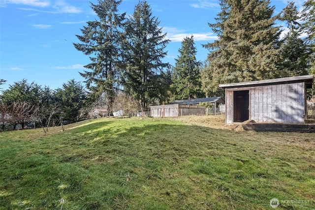 view of yard featuring a storage shed and an outdoor structure