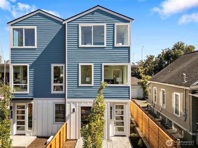 view of front of house with fence private yard and board and batten siding