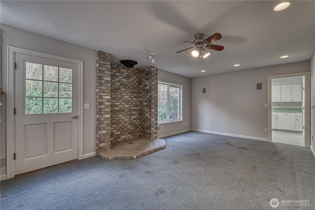 unfurnished living room featuring a ceiling fan, baseboards, and carpet flooring