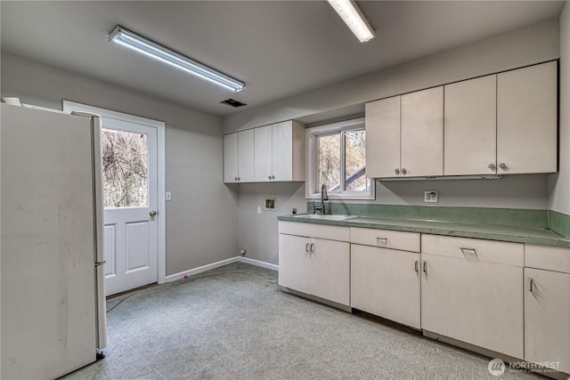 washroom with cabinet space, visible vents, light floors, washer hookup, and a sink