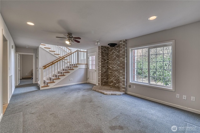 unfurnished living room with carpet floors, recessed lighting, stairway, ceiling fan, and baseboards