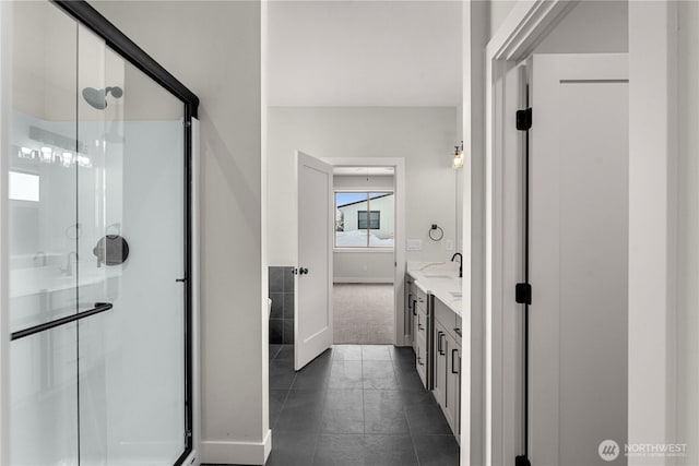 full bath with tile patterned flooring, a sink, a shower stall, and double vanity