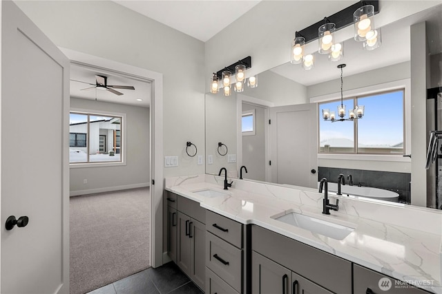 bathroom featuring double vanity, a healthy amount of sunlight, and a sink