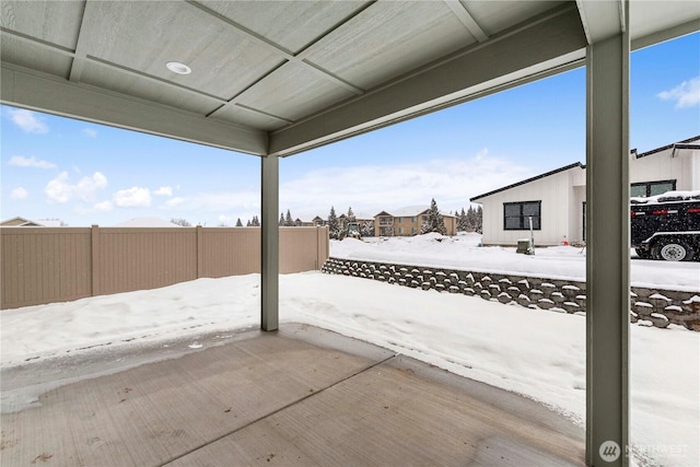 snow covered patio with fence