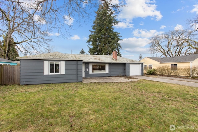 single story home with concrete driveway, a front lawn, an attached garage, and fence