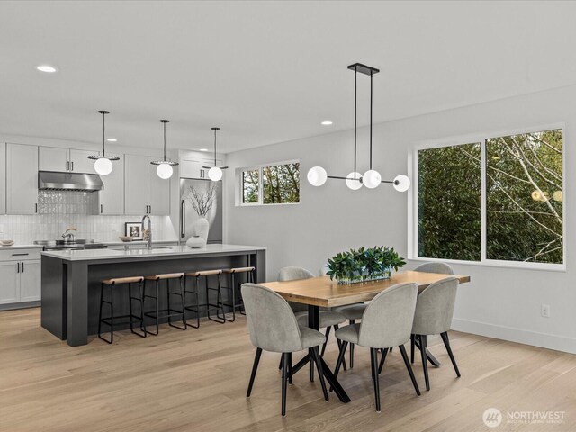 dining space featuring baseboards, recessed lighting, and light wood-style floors