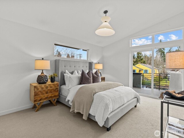 carpeted bedroom featuring vaulted ceiling, multiple windows, baseboards, and access to exterior