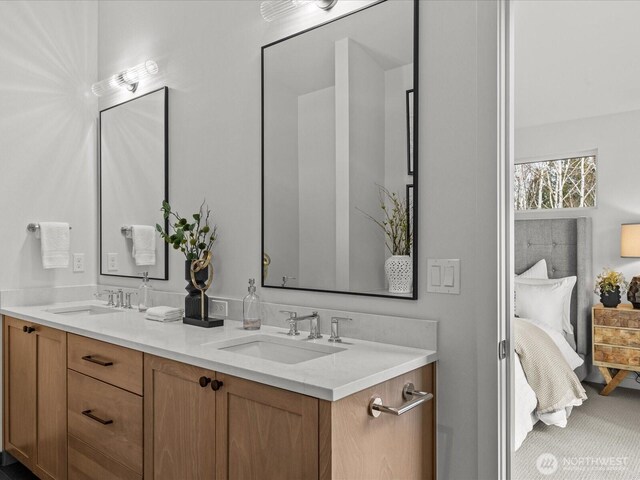 ensuite bathroom with ensuite bathroom, double vanity, and a sink