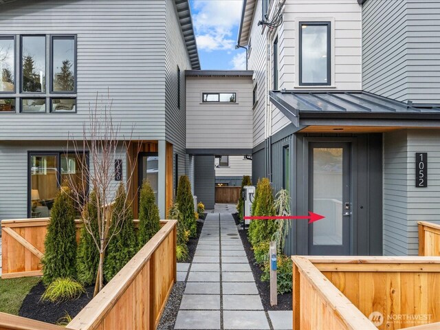 back of property featuring metal roof and a standing seam roof