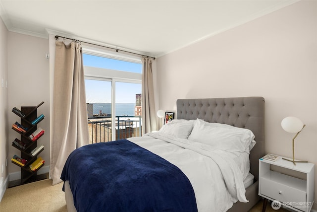 carpeted bedroom featuring access to outside, a water view, and crown molding