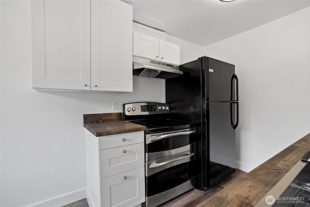 kitchen with range with two ovens, butcher block countertops, white cabinetry, and under cabinet range hood