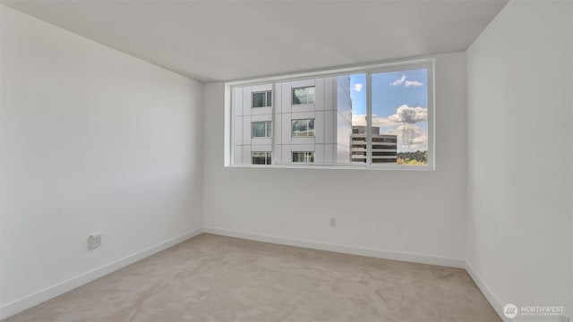 300 110th Ave NE Unit 605, Bellevue, WA 98004 - spare room featuring light colored carpet and baseboards
